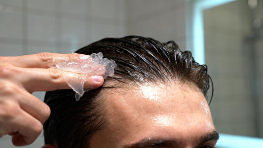 Hair gel being applied to hair, close-up shot.