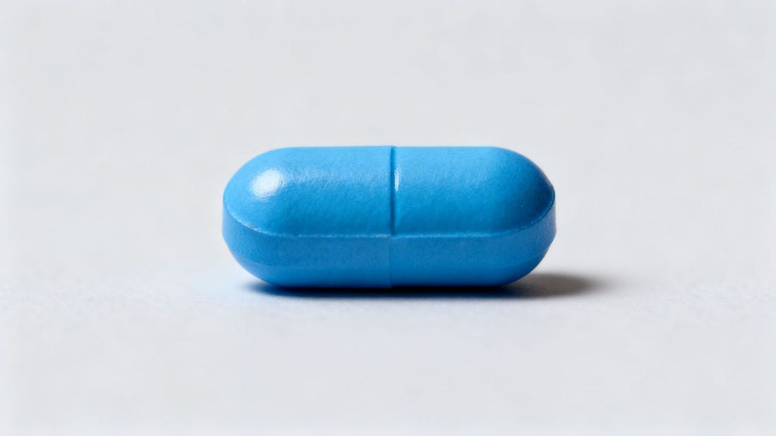 Single blue Viagra pill on a neutral background.
