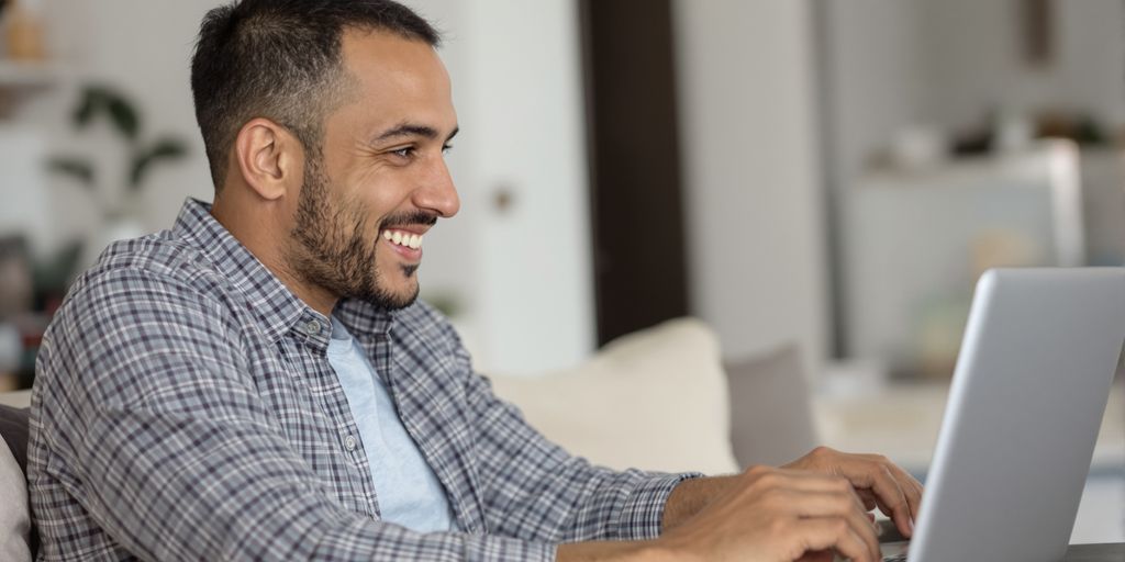 Man smiling during a telehealth consultation.